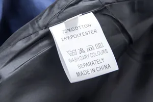 Detail of wash care label showing 75% cotton and 25% polyester composition