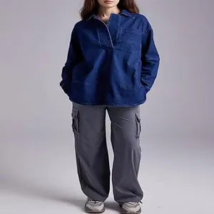 Femme en veste en jean col V bleu foncé et pantalon cargo gris en studio