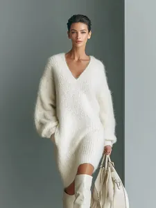 Elegant white V-neck oversized knit sweater dress styled with tall boots and handbag