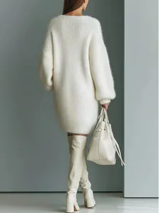 Back view detail of a loose white knitted sweater dress with long sleeves