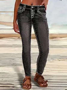 Close-up of slim fit stretch skinny jeans with white contrast stitching and button fly