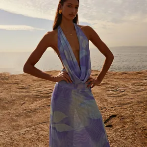Elegant purple marble print mesh halter top and maxi skirt set on coastal background