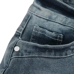 Detailed view of the front pocket and premium stitching on high-stretch blue denim jeans.