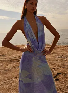Elegant purple printed halter-neck maxi dress with deep V-neck and backless design