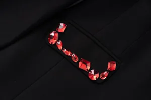Close-up of luxurious red gemstone embellishments on a women's black party blazer