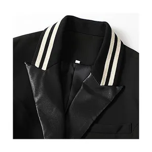 Sophisticated black blazer featuring a striped ribbed collar and faux leather lapels detail