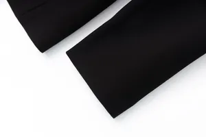 Macro detail of the straight cuff on a premium black women's suit jacket blazer