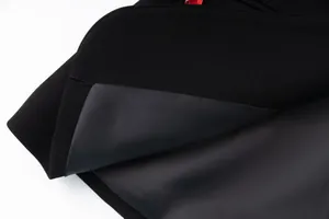 Close-up showing the smooth grey lining and premium black fabric texture of women's luxury blazer