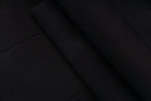 Detailed macro view of black twill blazer fabric showing fine texture and weave