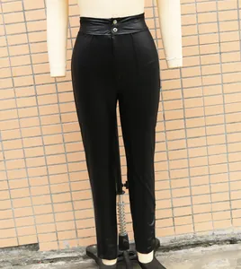 Macro view showing the texture and high-waist fit of black stretchy PU leather leggings.