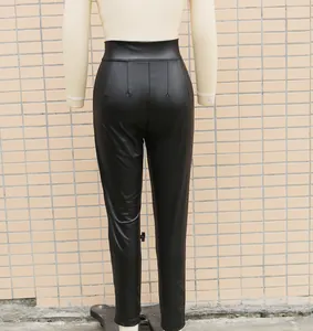 Back view of black high waist faux leather leggings on a mannequin showing texture.