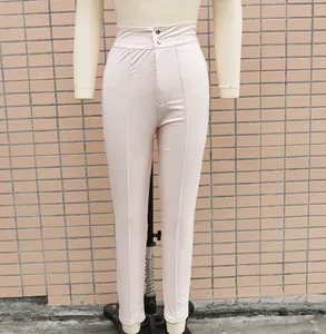 Close-up detail of high-waisted pink stretch PU leather leggings shown on a mannequin