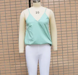 Loose fit mint green V-neck sleeveless camisole top shown on a white sizing mannequin