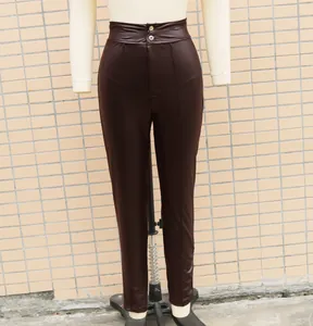 Detailed view of high-waist stretch PU leather skinny leggings in a deep dark brown color