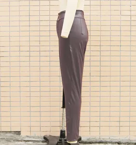Detailed side view of high-waisted elastic brown faux leather leggings on a mannequin.