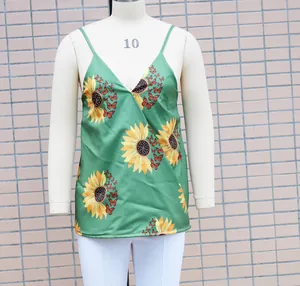 Detailed view of women's green V-neck camisole top with sunflower and butterfly print