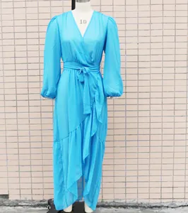 Close-up of bright blue chiffon wrap dress with ruffled hem and belted waist