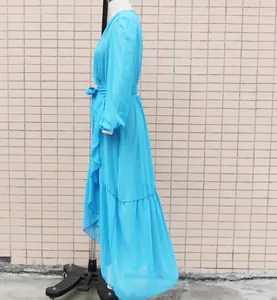 Side view of light blue chiffon maxi dress with ruffles and waist tie on mannequin.