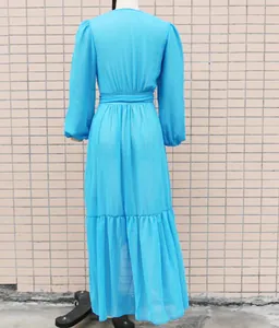 Detailed back view of a long-sleeved light blue chiffon maxi dress on a display mannequin