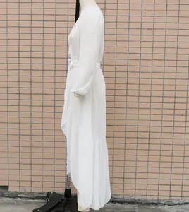 Detailed side view of white chiffon long dress with elegant ruffle hem for beach vacation