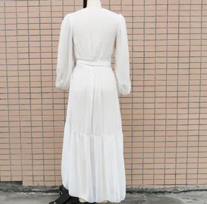 Detailed back view of a white chiffon maxi dress with long puff sleeves and a waist tie.