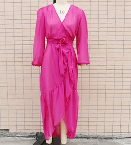 Detail shot of hot pink chiffon vacation dress with wrap V-neck and ruffled hemline