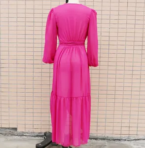 Back view of a vibrant magenta chiffon long-sleeved maxi dress on a mannequin stand.