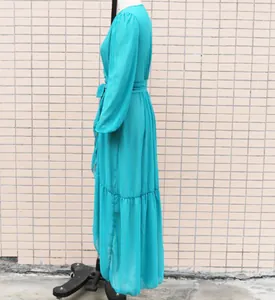 Side profile of a teal chiffon long-sleeve wrap maxi dress displayed on a mannequin