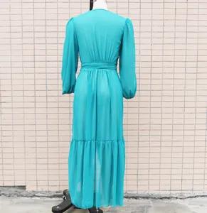 Rear view of a teal chiffon maxi beach cover-up dress displayed on a mannequin.