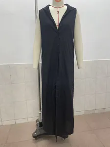 Detailed view of a black sleeveless hooded button-down maxi dress on a mannequin stand