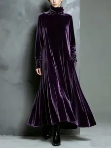 Elegant purple velvet maxi dress with a high stack neck and flowing wide hem detail