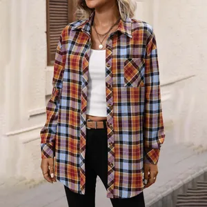 Detailed view of the oversized vintage plaid pattern and button-down front on a long sleeve shirt.