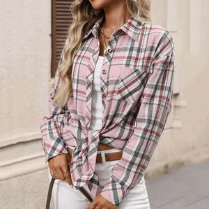 Close-up detail of women's pink retro plaid long-sleeved shirt featuring a tie-front hem