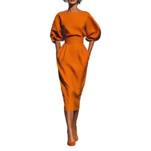 Ensemble de vacances élégant avec haut orange à manches bouffantes et jupe midi plissée