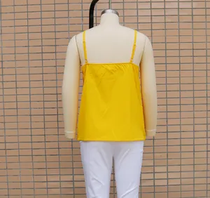 Detailed back view of a bright yellow loose casual camisole tank top on a mannequin