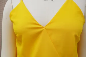 Close-up detail of a bright yellow V-neck casual camisole showing fabric texture and seams