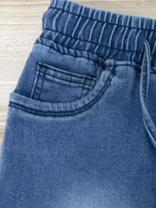 Vista detallada de shorts vaqueros de mujer con cintura elástica, cordón y bolsillo frontal.