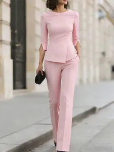 Elegant pink two-piece professional suit set with asymmetrical hem and straight trousers