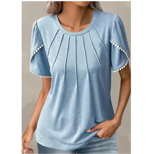 Close-up of blue t-shirt with pleated neckline and tulip sleeves featuring bead trim.