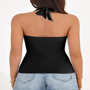 Detailed back view of a sexy black halter neck backless top paired with light blue jeans.