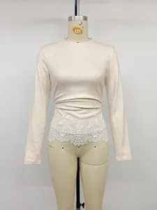 Elegant cream slim fit long-sleeved knitted top featuring intricate white lace patchwork detail