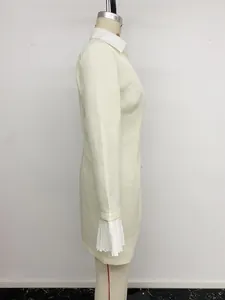 Side view of a cream fake two-piece blazer dress with elegant lace cuff details.