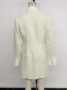 Detailed back view of an elegant cream blazer dress with pleated ruffled sleeve accents