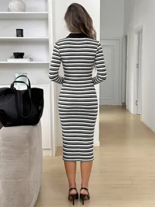 Elegant back view of a black and white striped long sleeve bodycon midi dress for women.