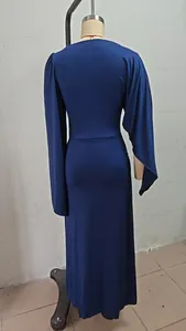 Detailed back view of an elegant dark blue slim fit evening gown with flowing cape sleeves