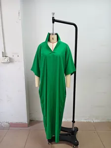 Close-up of green V-neck long dress on mannequin showing loose fit and mid-sleeves
