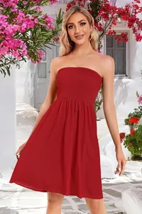 Vibrant red strapless smocked mini dress for women in a breezy summer vacation scene