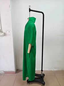 Side profile view of a loose green V-neck maxi dress with half sleeves on mannequin.