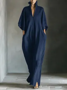 Detailed view of a navy blue V-neck maxi dress showing the loose fit and soft fabric texture