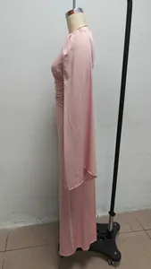 Side view detail of a pink floor-length evening dress with elegant pleated waist